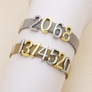 Detailed macro view of silver and gold mesh strap bracelets with numeric DIY charms
