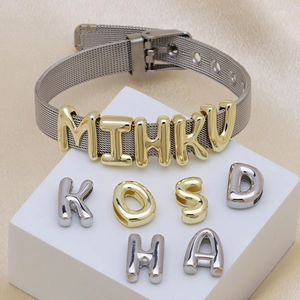 Detail of adjustable silver mesh band bracelet with personalized DIY sliding letters