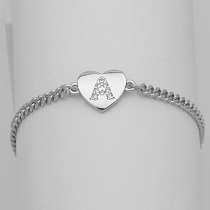 Close-up of a silver Cuban chain bracelet featuring a crystal-encrusted heart and letter A
