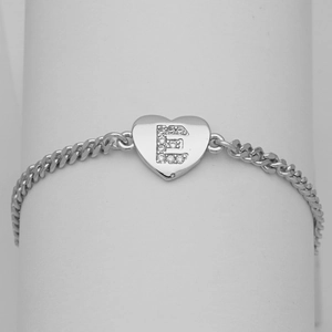 Close-up of heart charm bracelet with crystal paved letter E on a silver Cuban chain