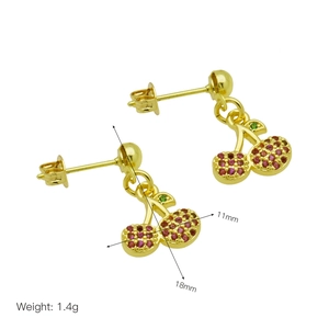 Detailed view of cherry drop earrings featuring pink crystals and gold-plated finish