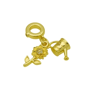 Detail view of golden sunflower and watering can charms with rhinestone accents