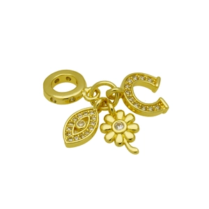 Detailed macro view of gold-plated clover, evil eye, and horseshoe charms with zircons