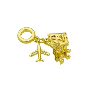 Detailed close-up of golden Eiffel Tower and airplane travel charms with engraved mail tag
