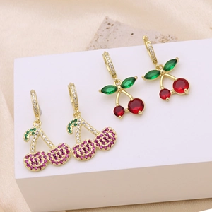 Fashionable cherry earrings with red and green cubic zirconia in gold plating