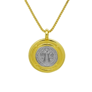 Detailed view of bicolor St. Benedict medal pendant on a gold box chain necklace