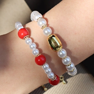 Red lantern beads and pearl layered bracelet set with gold accents for elegant women