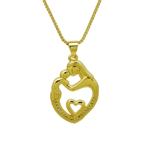 Macro shot of gold heart pendant featuring a mother and child silhouette with crystals