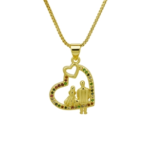 Macro shot of gold heart pendant with couple figure and multicolored stones