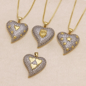 Pendenti a cuore bicolore oro e argento con motivi stella e corona su seta pregiata
