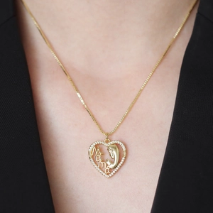Golden heart necklace with 'Mama' cutout, mother and child silhouette and zircon stones