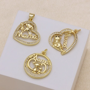 Three golden heart pendants with Mama engraving and white zircon stones on white blocks