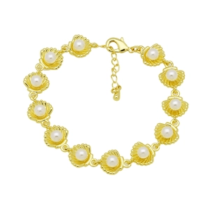 Detailed macro view of golden shell link bracelet with white pearls and lobster clasp