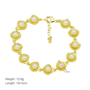 Detailed view of gold scallop shell bracelet with white pearls and lobster clasp closure