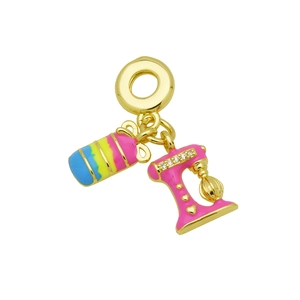 Detailed macro of golden kitchen mixer charm with pink enamel and sparkling zircon accents