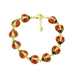 Close-up of ladybug charm bracelet with red enamel and sparkling white rhinestones