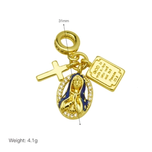 Macro detail of a gold religious charm set with blue enamel Virgin Mary and small cross