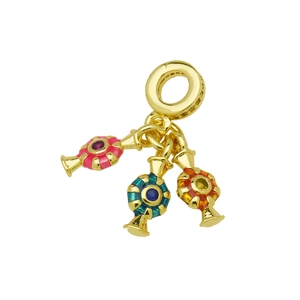 Detailed macro view of golden charm with colorful enamel and miniature gemstones