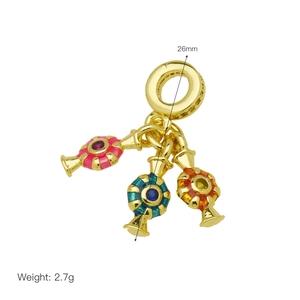 Detail view of 26mm gold pendant with colorful enamel candy charms and gemstones