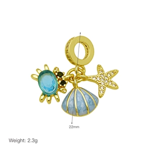 Golden ocean charm featuring a blue gem crab, enamel shell, and crystal starfish