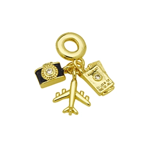 Macro detail of gold travel charms featuring camera, airplane and passport design