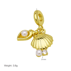 Macro shot of seashell pearl pendant with gold plating and cubic zirconia for bracelets