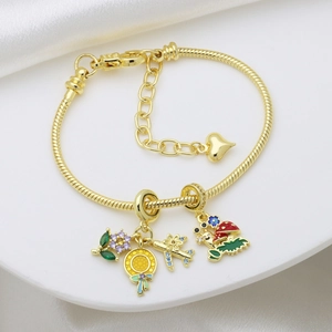 Golden snake chain charm bracelet with purple flower, airplane, and mushroom pendants