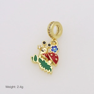 Detailed macro view of a snail and mushroom charm with red enamel and sparkling cubic zirconia