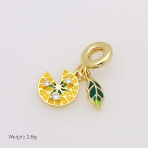 Macro shot of gold lemon pendant with yellow enamel and green leaf charm, 2.8g weight