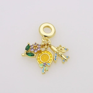 Detail of gold charms with enamel tropical leaves and gemstone-set airplane pendant