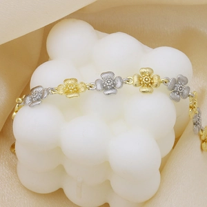 Two-tone floral sunflower charm bracelet with textured petals on a beige fabric background