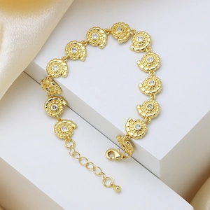 Gold shell link bracelet with white zircon stones and adjustable lobster clasp closure