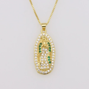 Close-up of gold Virgin Mary pendant with green and white cubic zirconia stones