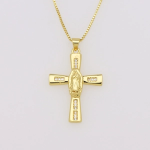 Macro view of gold cross pendant necklace with virgin mary engraving and zircon stones