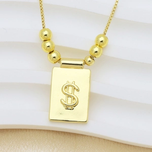 Pendentif rectangulaire plaqué or 18K avec signe dollar en relief et petites billes dorées