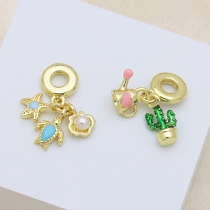 Golden ocean starfish turtle and pink heart watering can enamel charms on white blocks