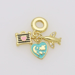Macro detail of gold travel charms with blue enamel world map heart and a mini airplane