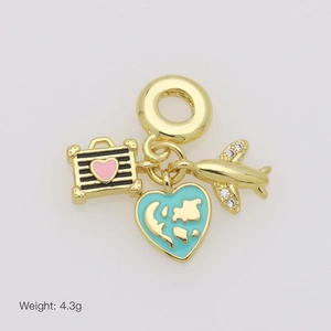 Golden travel charm pendant featuring suitcase, blue globe, and airplane charms