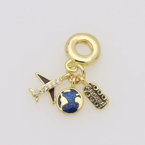 Detailed close-up of gold travel charms featuring a plane, glitter globe, and ticket tag