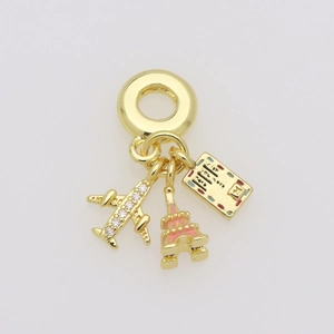 Detailed gold travel charms featuring an airplane, pink Eiffel Tower, and Paris ticket tag