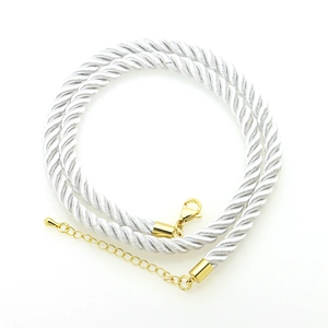 Detailed macro view of 6mm twisted polyester cord with gold lobster clasp and extension chain