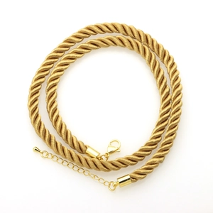 Detailed close-up of 6mm golden twisted polyester rope necklace with lobster clasp and extender