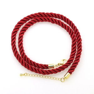 Macro shot of 6mm red twisted polyester cord necklace with gold lobster clasp and chain