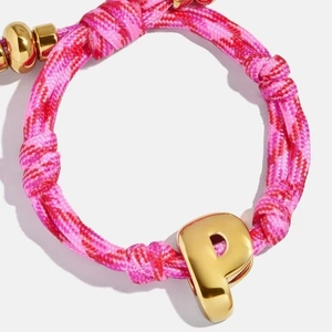 Colorful hand-woven cord bracelet with a gold metal letter P pendant for personalized style