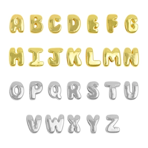 Macro shot of 26 3D bubble style alphabet pendants in polished gold and silver finishes