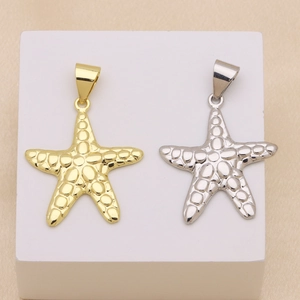 Detailed macro view of 18K gold and silver plated starfish pendants with pebble textures