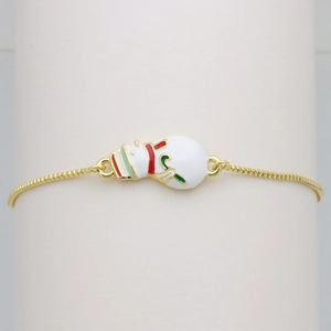 Macro view of gold chain with white enamel snowman charm for Christmas gift