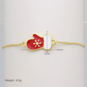 Detail of Christmas glove pendant with golden snowflake on a box chain bracelet