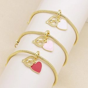 Three gold snake chain bracelets with sparkling hollow hearts and colorful enamel charms