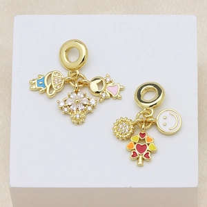 Golden enamel charms featuring boy, girl, flower and heart tree designs with zircons